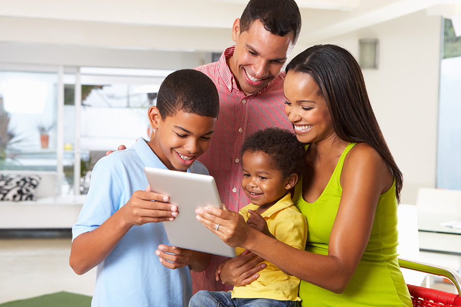 Client Center - Happy Family Using a Tablet in Their Kitchen Together at Home