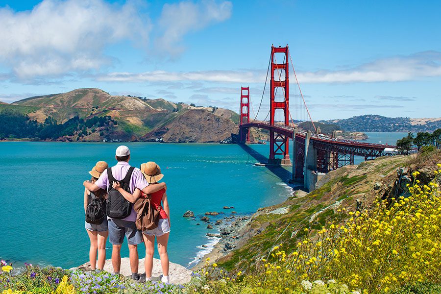 Employee Benefits - A Family Enjoying Time Together on a Vacation Hiking Trip Stopping to Look at the Golden Gate Bridge and Mountains in the Distance